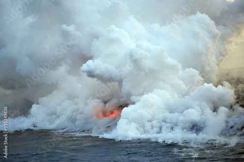 Volcanic lava flows into ocean waves