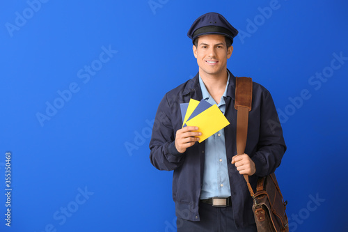 Handsome young postman on c...