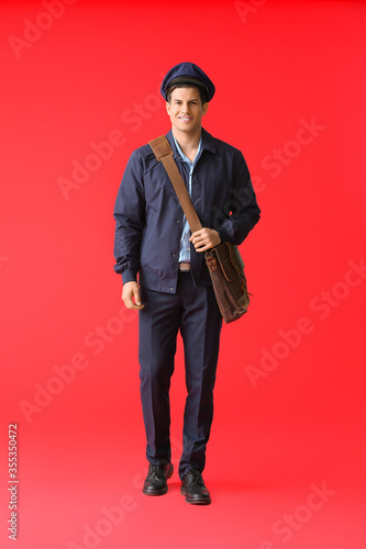 Handsome young postman on c...
