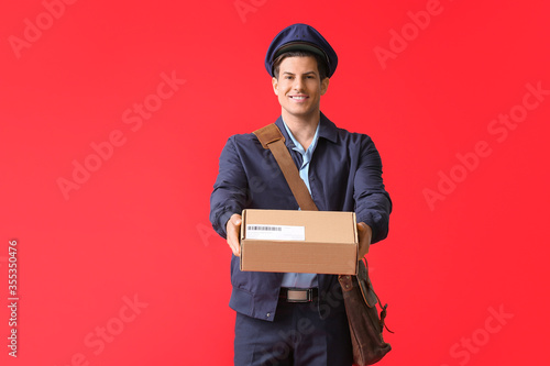 Handsome young postman on c...