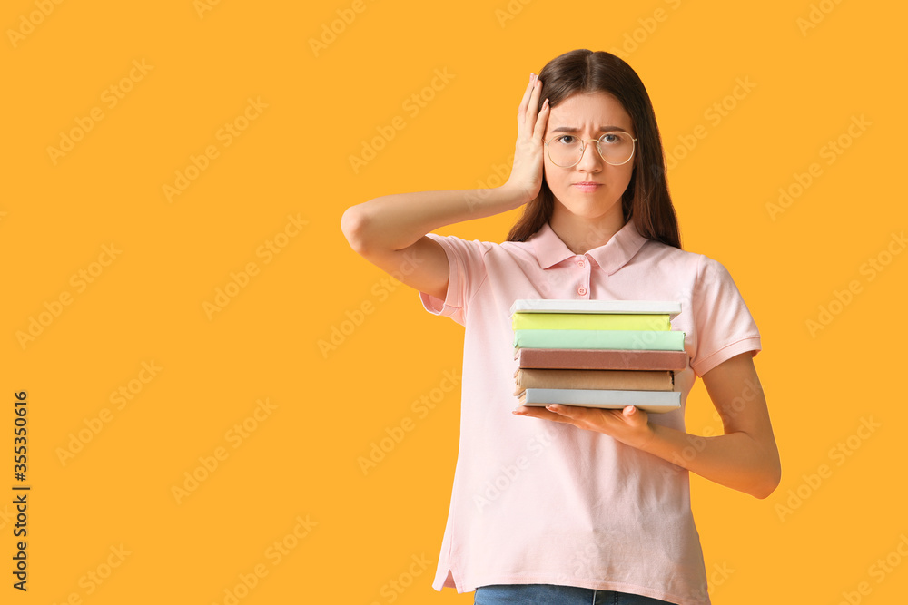 Stressed student with books on color background Stressed student with books on color background