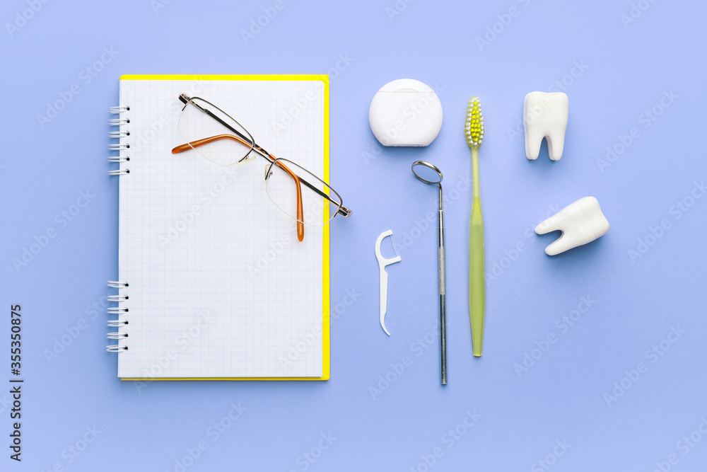 Set for oral hygiene with notebook and eyeglasses on color background Set for oral hygiene with notebook and eyeglasses on color background