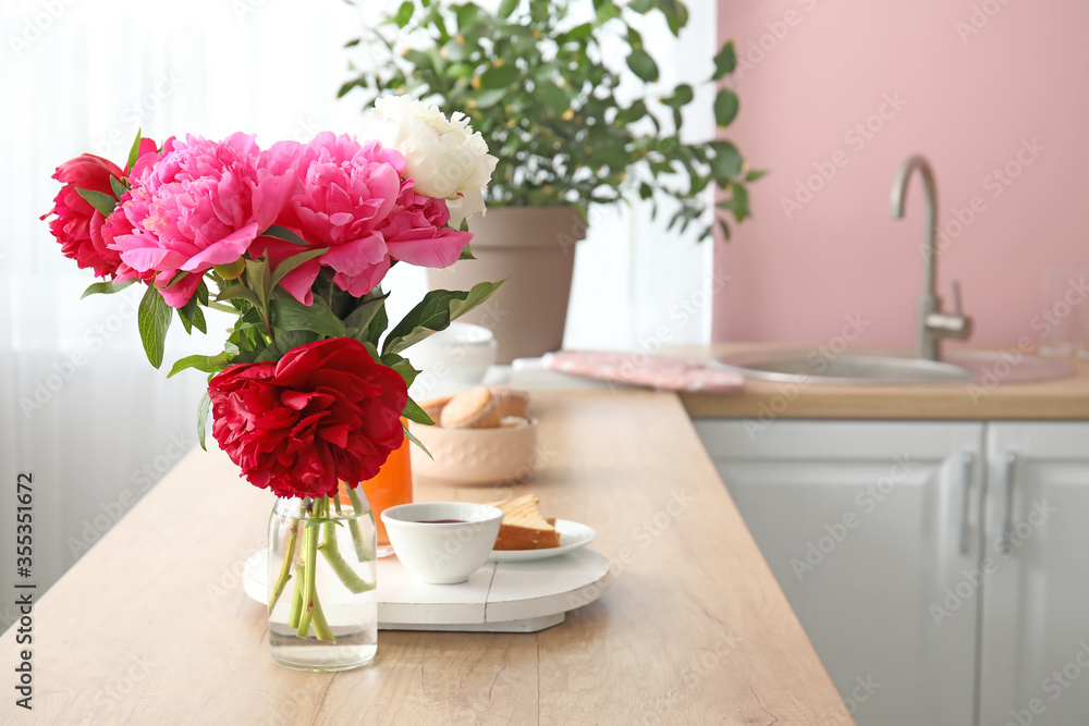 Bouquet of flowers on table in modern kitchen Bouquet of flowers on table in modern kitchen