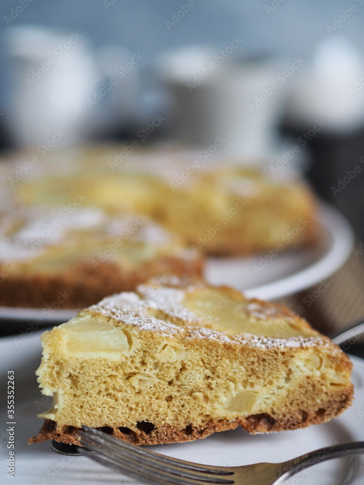 Home cooking.Sponge cake with pineapple on a dark background.