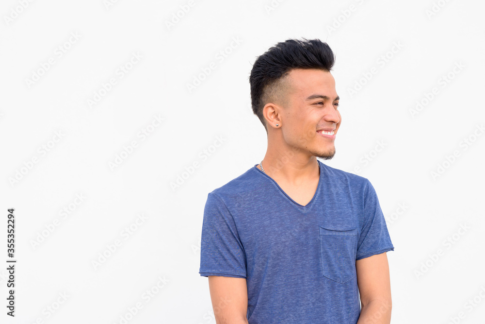 Face of happy young handsome multi ethnic man thinking against white background Face of happy young handsome multi ethnic man thinking against white background