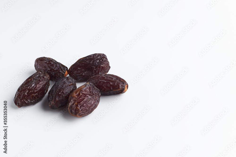 handful of sluggish dates on a white background. dried fruits isolate. copy space for text handful of sluggish dates on a white background. dried fruits isolate. copy space for text