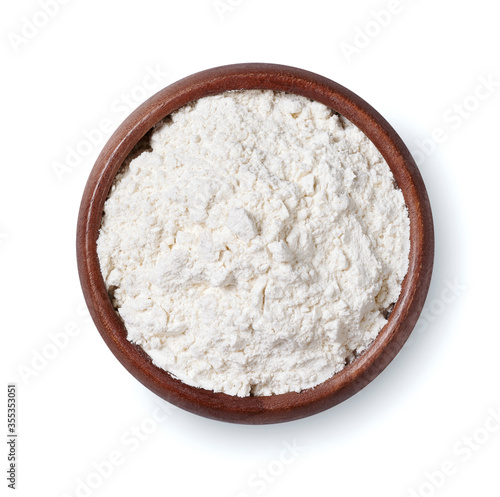 Wooden bowl of flour isolated on a white background. Top view.