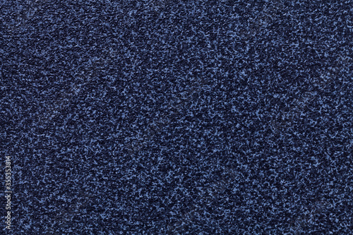 Grainy navy blue background with spotted pattern. Texture backdrop with small crumb pattern for interior design.