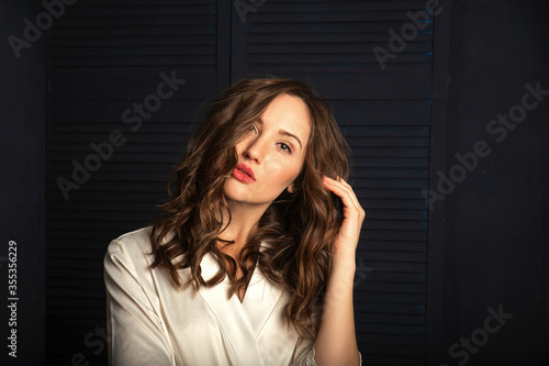 Closeup portrait of gorgeous young woman in white bathrobe. Closeup portrait of pretty girl with curly hair
