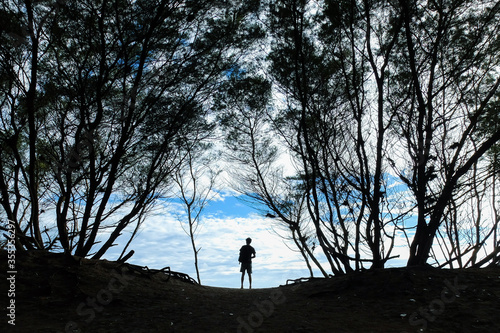 silhouette of a woman walking on a hill