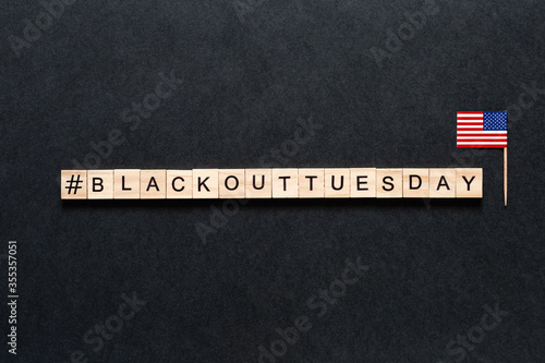 Blackout tuesday inscription on a black background. Black lives matter, blackout tuesday 2020 concept. unrest. rallies. brigandage. marauders. looting. American flag. USA photo