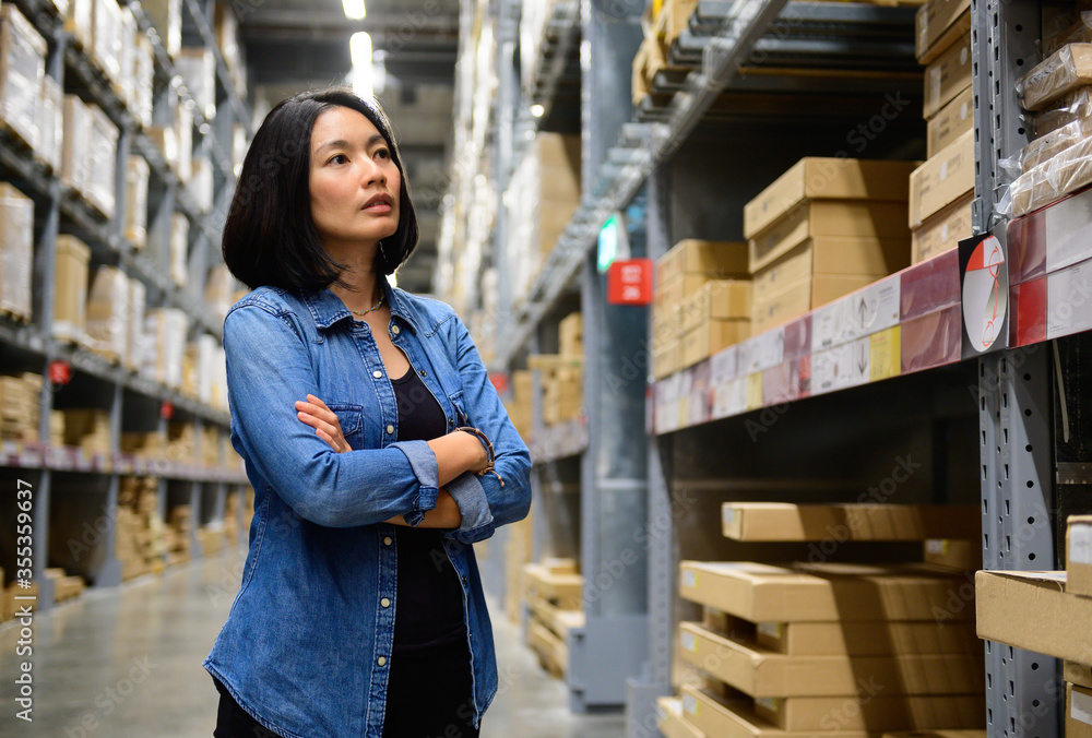 Portrait of female manager with arms crossed in warehouse Portrait of female manager with arms crossed in warehouse