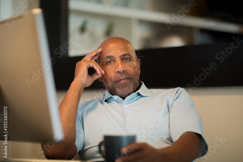 Mature African American man working from his home office. photo