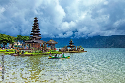 Bratan Lake, Bali - November 25th, 2017: Tourist taking a cannoe trip to get closer view of Ulun Danu Bratan tample. The temple complex is located on the shores of Lake Bratan 