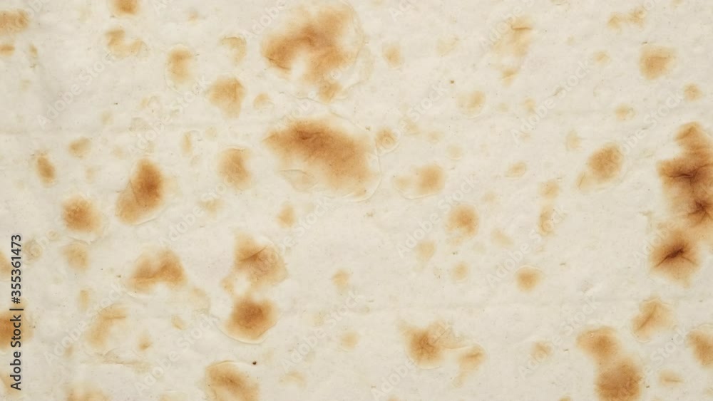 Armenian bread lavash rotating top view. Amazing macro background with vibrant texture Armenian bread lavash rotating top view. Amazing macro background with vibrant texture