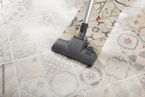 cleaning floor with modern vacuum cleaner in kitchen room. easy cleaning with vacuum cleaner