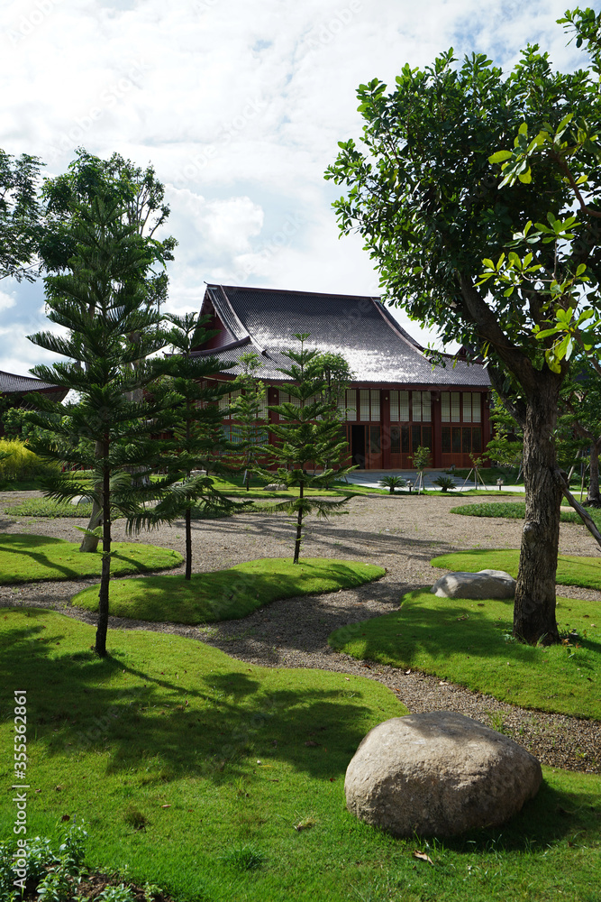 Exterior architecture and decoration of traditional oriental style building with green garden park arranged in Japanese zen design