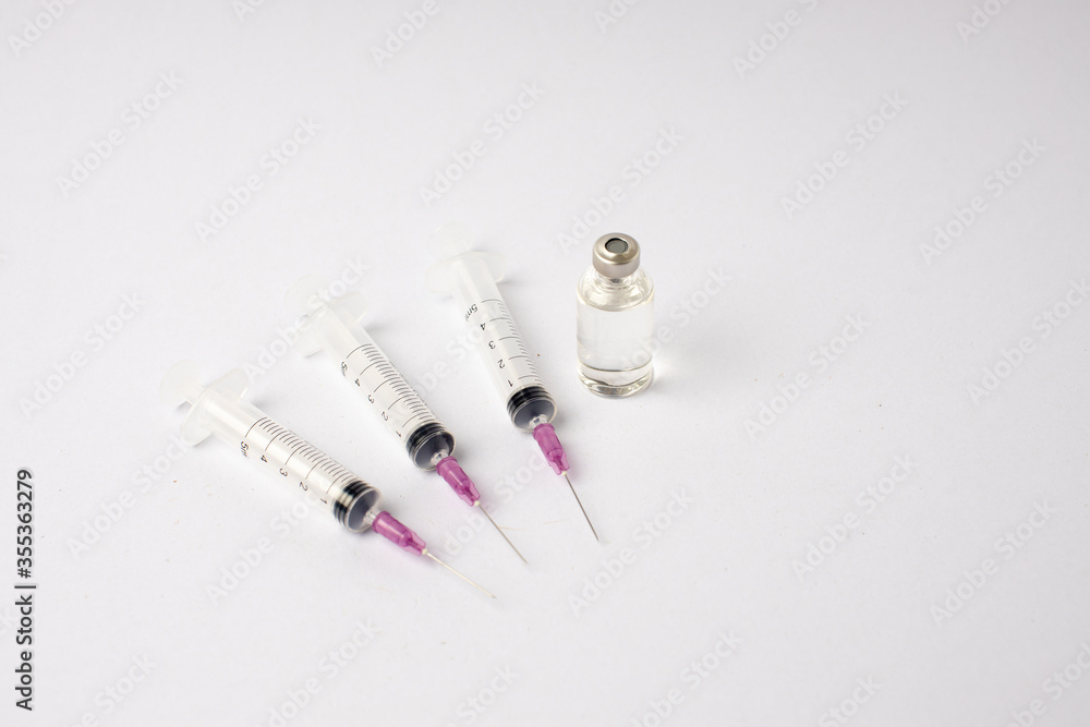 syringe, vaccine, lying on a white background syringe, vaccine, lying on a white background