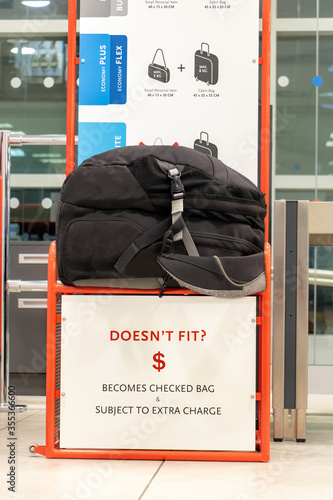 The oversize backpack lying on a control cage for measure size of carry on luggage. Checking baggage size at the airport. photo