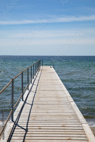 Bridge for bathing on the beach, blue sky 