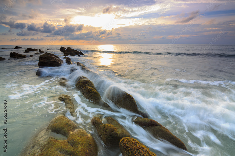 Obraz premium Amazing twilight Sunset seascape with sea wave hitting the green moss