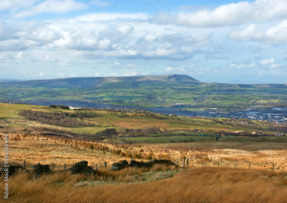 Moorland scene in Lancashire, north-east England, with Burnley town and Pendle Hill in the background