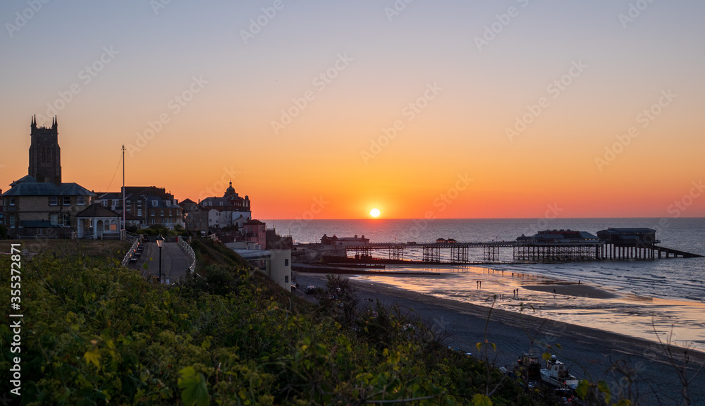 Cromer town and pier at sunset.