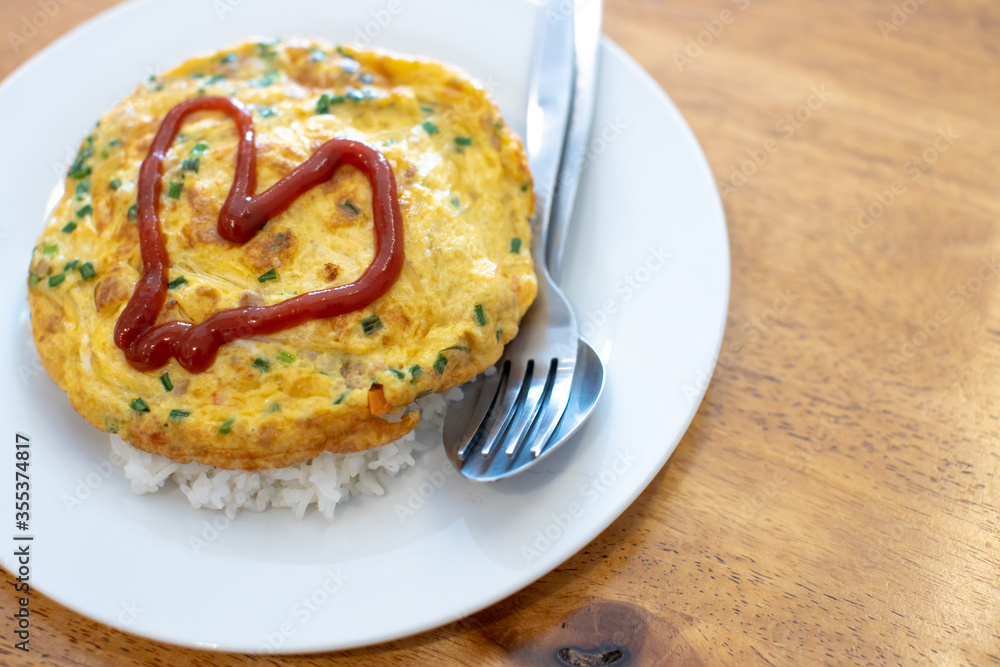 
Omelette on a white plate with red heart-shaped sauce