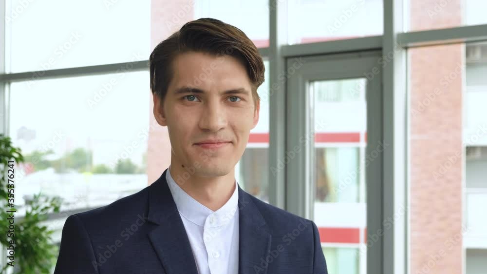 Handsome european man with trendy hairdo studio background. Cheerful guy smiling and looking to camera. 4k Handsome european man with trendy hairdo studio background. Cheerful guy smiling and looking to camera. 4k