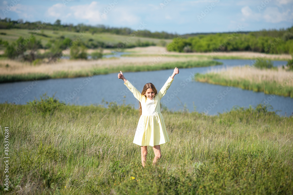 Green wheat field. Beautiful girl walks in the field. A child with a basket collects spikelets. Recreation and agriculture. Long hair of a young girl Green wheat field. Beautiful girl walks in the field. A child with a basket collects spikelets. Recreation and agriculture. Long hair of a young girl