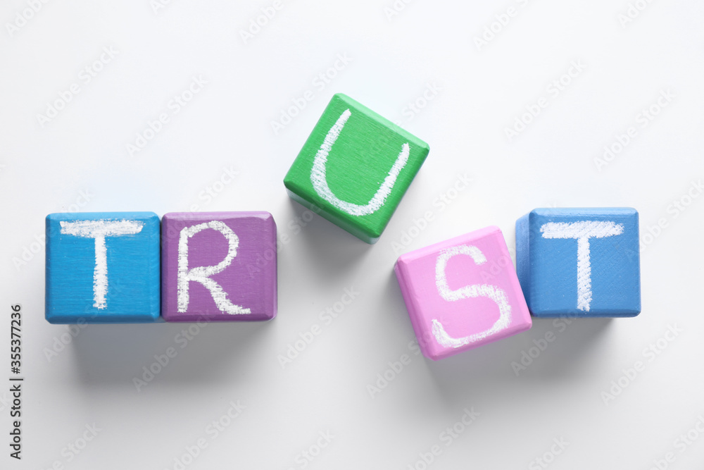Cubes with word TRUST on white background, top view. Concept of jealousy Cubes with word TRUST on white background, top view. Concept of jealousy