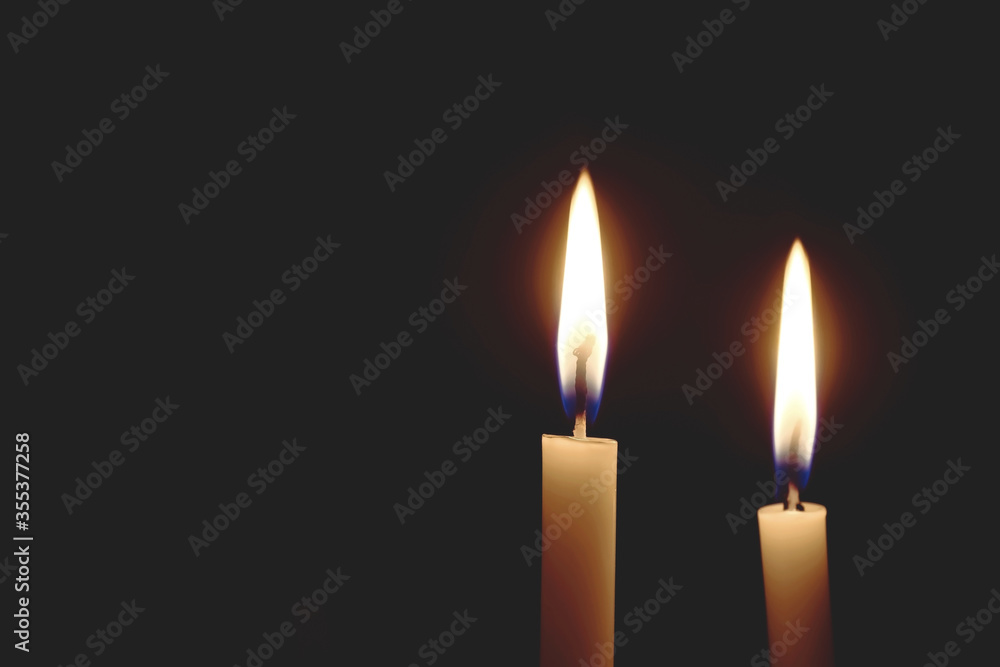 light the room dark. Candle lit in the dark, Candle flame at night, Lighting design for background, Two candles that shine in the dark. light the room dark. Candle lit in the dark, Candle flame at night, Lighting design for background, Two candles that shine in the dark.