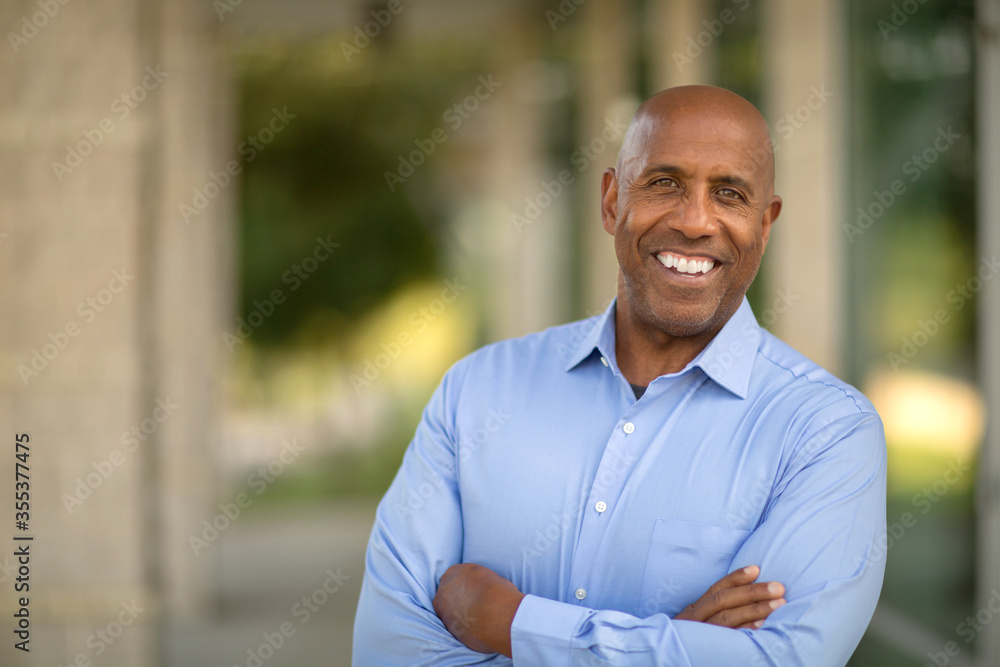 Happy mature African American man at work. - obrazy, fototapety, plakaty 
