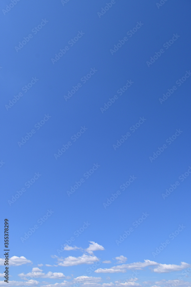 White fluffy clouds on the blue sky, nature background.