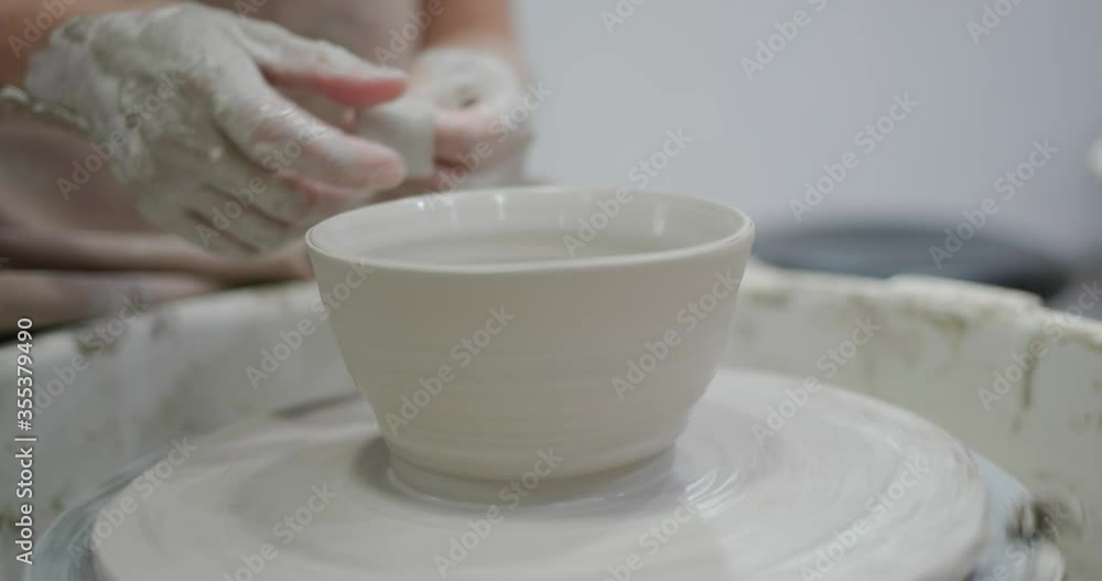 Potter making ceramic pot on the twisted pottery wheel Potter making ceramic pot on the twisted pottery wheel