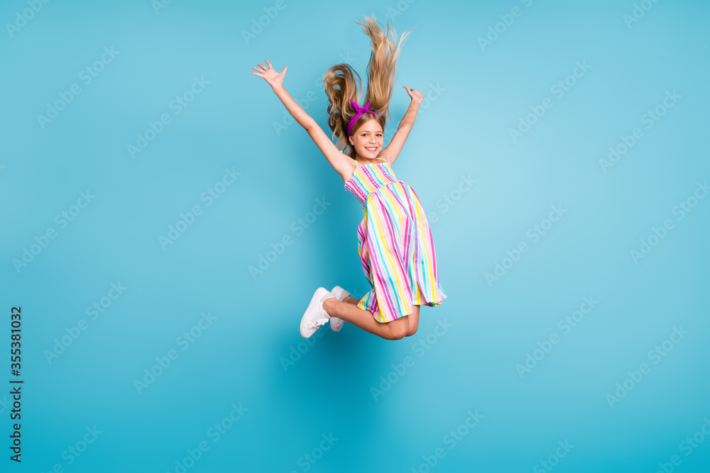 Full length body size view of her she nice attractive lovely pretty charming cute glad cheerful cheery free girl jumping enjoying leisure isolated over bright vivid shine vibrant blue color background