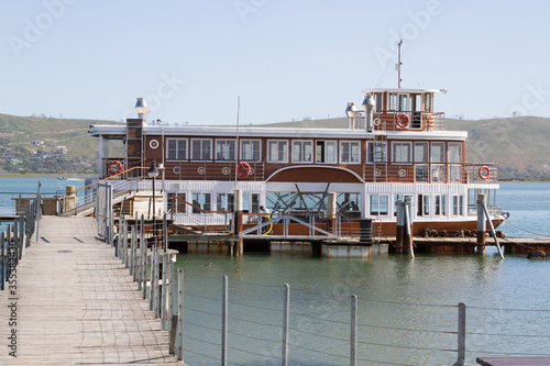 Paddle wheel cruise boat at anchor at jetty Knysna South Africa