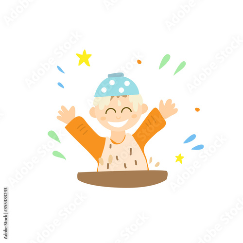 A baby puts a plate with porridge on his head. Happy childhood. Games at the table while eating.