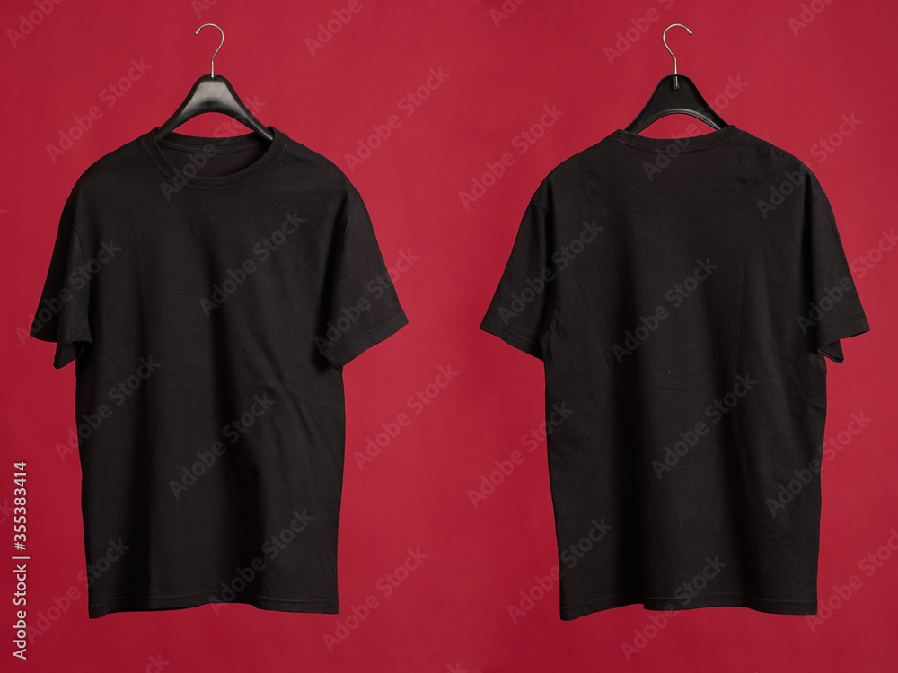 Exclusive hanger with empty black t-shirt hanging isolated on a red ...