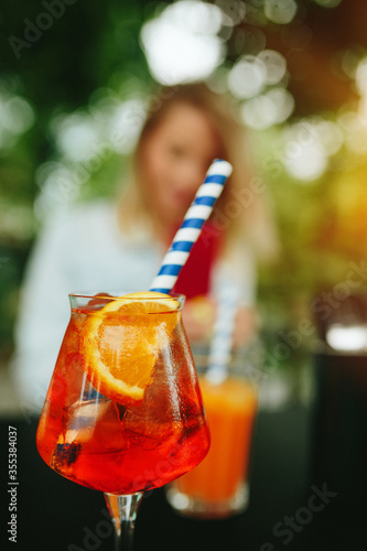 Glass of Aperol Spritz and blue straw, Italian Cocktail