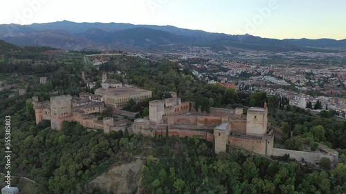 Wallpaper Mural Aerial panning shot of famous palace amidst trees on hill against sky, drone flying over cityscape during sunset - Granada, Spain Torontodigital.ca