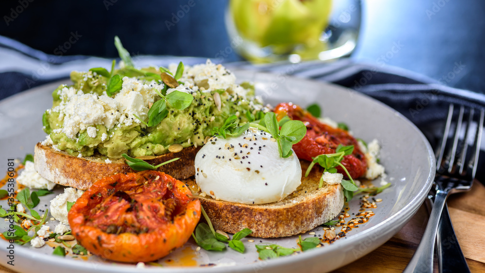 Avocado Toast featuring smashed avocado, grilled tomatoes, boiled egg on sourdough toast Avocado Toast featuring smashed avocado, grilled tomatoes, boiled egg on sourdough toast