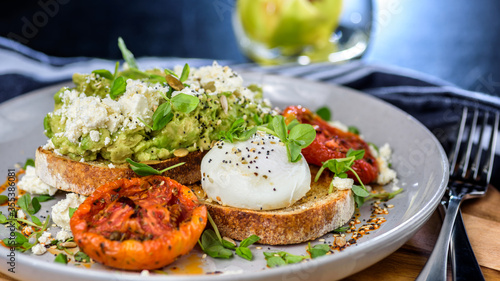 Avocado Toast featuring smashed avocado, grilled tomatoes, boiled egg on sourdough toast