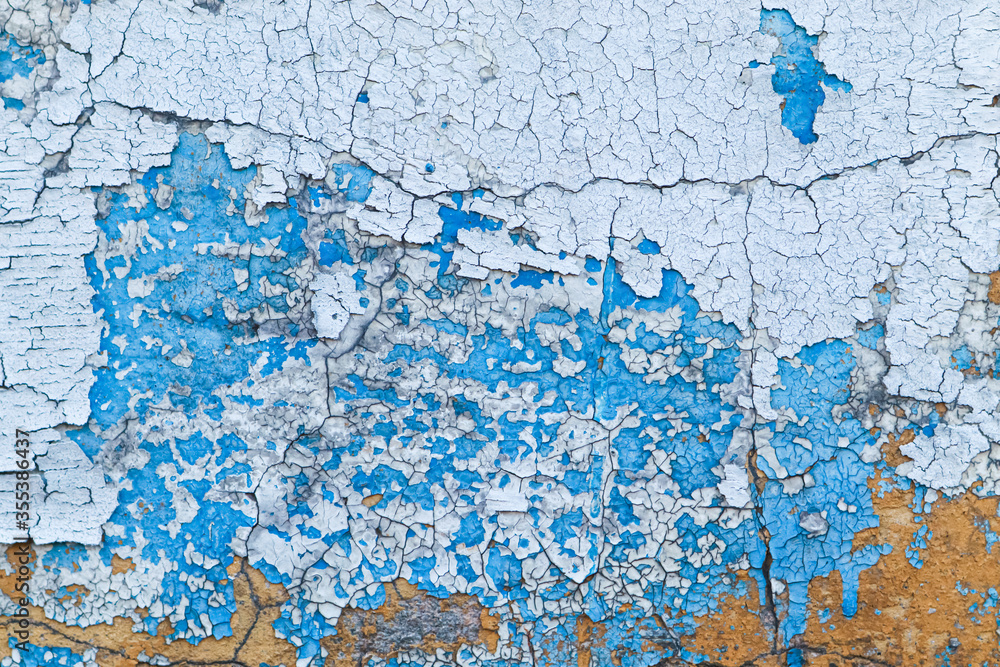Old peeling blue painted wall. Close up