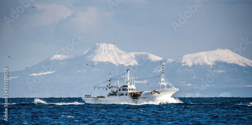 Obraz na plátně Fishing boat returns after fishing to its port