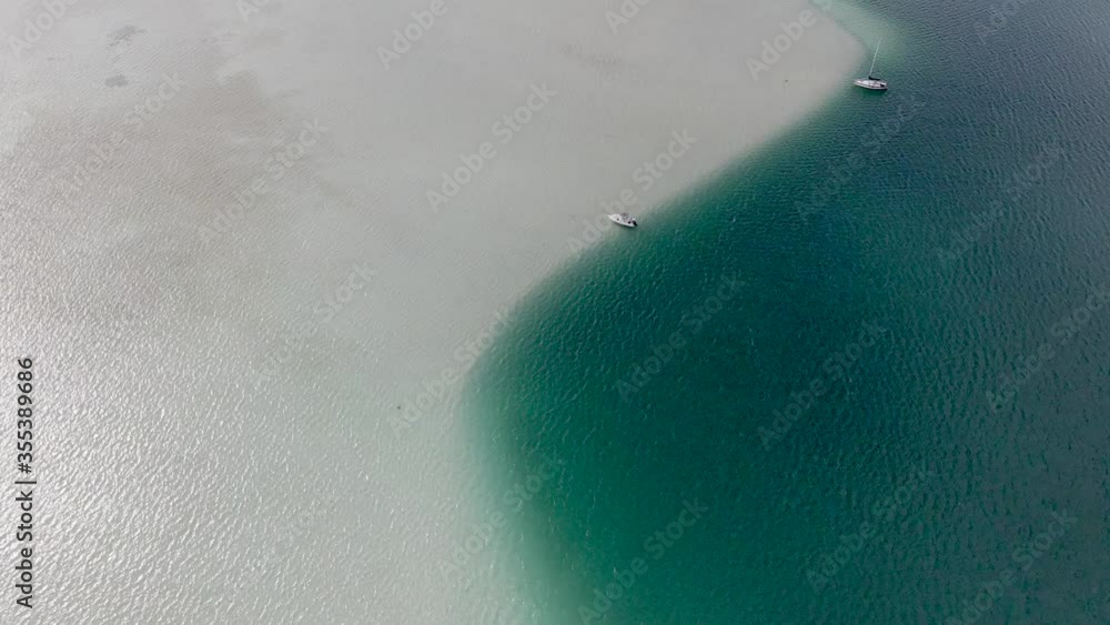 Aerial drone top down view over boats docked along beautiful Kaneohe Bay Sandbar in Oahu, Hawaii. Aerial drone top down view over boats docked along beautiful Kaneohe Bay Sandbar in Oahu, Hawaii.