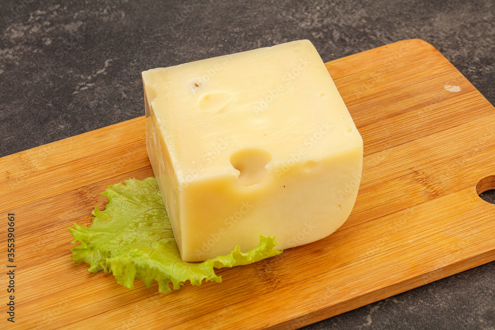 Emmental cheese over wooden board