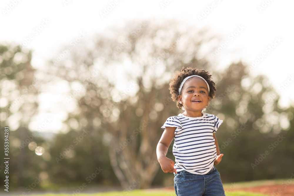 Happy little girl laughing and smiling outside. Happy little girl laughing and smiling outside.