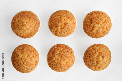 cupcakes on a white background, arranged in two rows, isolated, shot from above