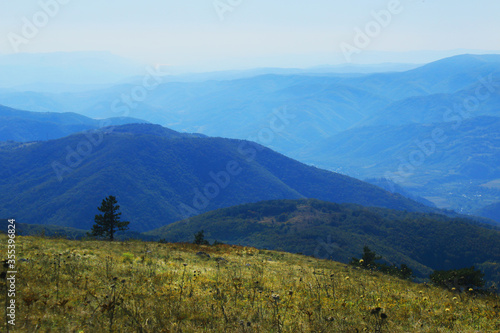 Mountain peaks landscape. Hiking. Blue degrade background on a sunny day. Excursion and mountains.